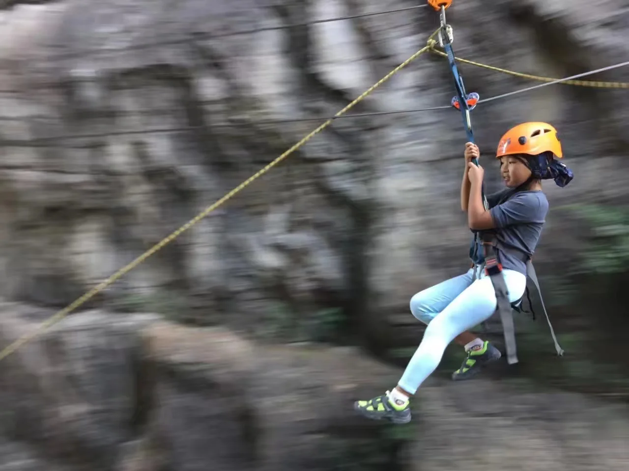 Group of participants gearing up with helmets and harnesses at the via ferrata start point in Yangshuo